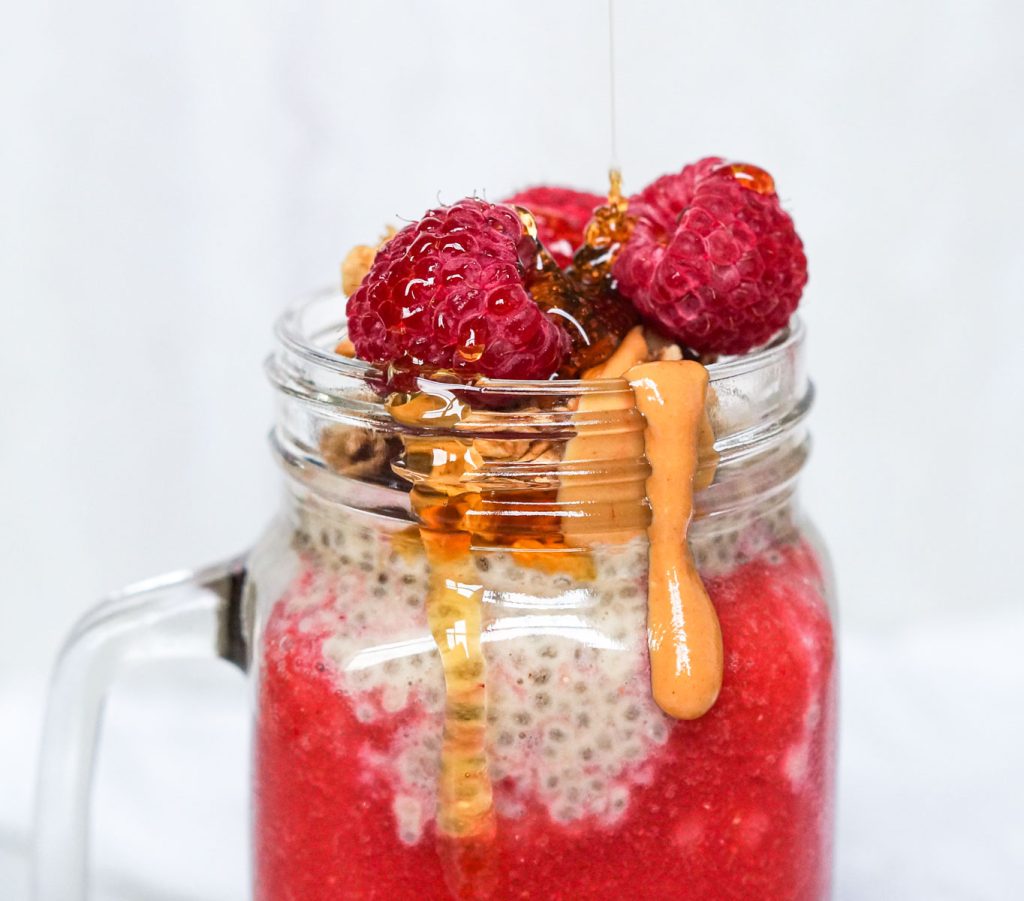 Chia pudding with raspberries, peanut butter, and granola