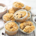 Stack of banana coconut chocolate chip muffins on a cooling rack