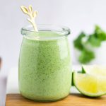 Jar of cilantro lime ranch with a gold spoon.