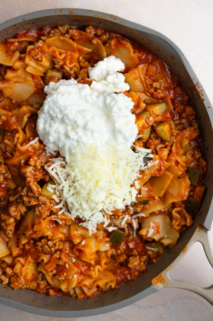 Lasagna skillet with cottage cheese and mozzarella on top.