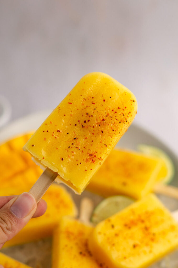 Closeup of a mango popsicle with tajin.