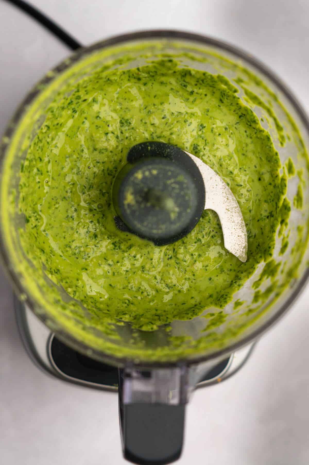 Food processor filled with basil cashew pesto.