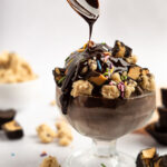 Ninja Creami protein ice cream with hot fudge, cookie dough, sprinkles, and peanut butter cups.