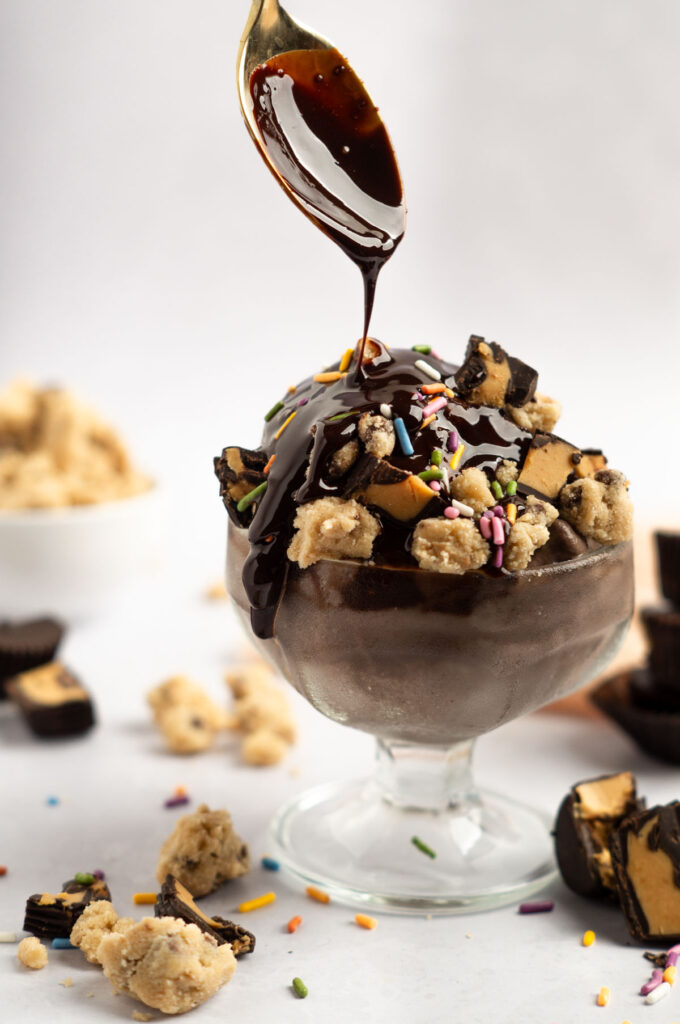 Ninja Creami protein ice cream with hot fudge, cookie dough, sprinkles, and peanut butter cups.