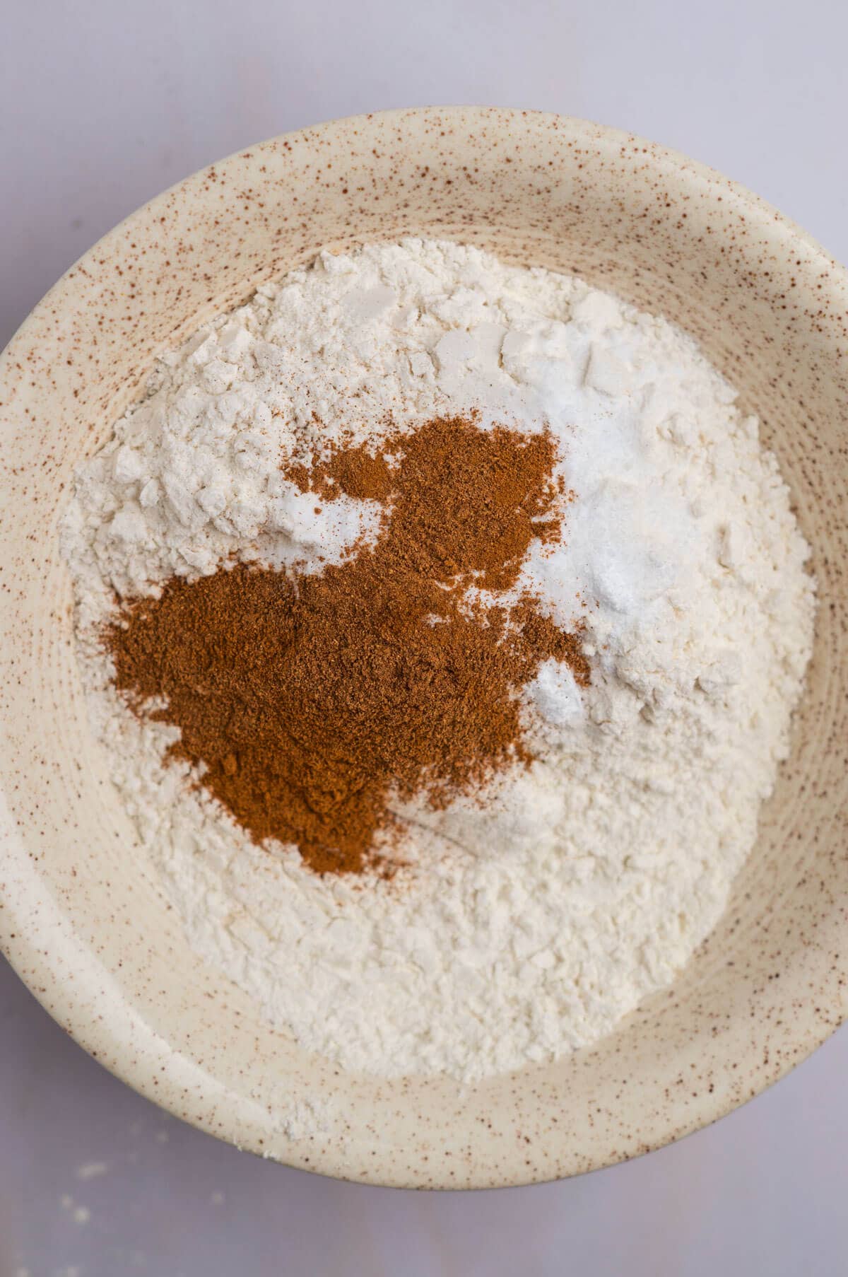 A bowl with the dry ingredients needed for the spice cake.