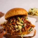 Crockpot chicken sandwich with apple cabbage slaw and a side of BBQ slaw.