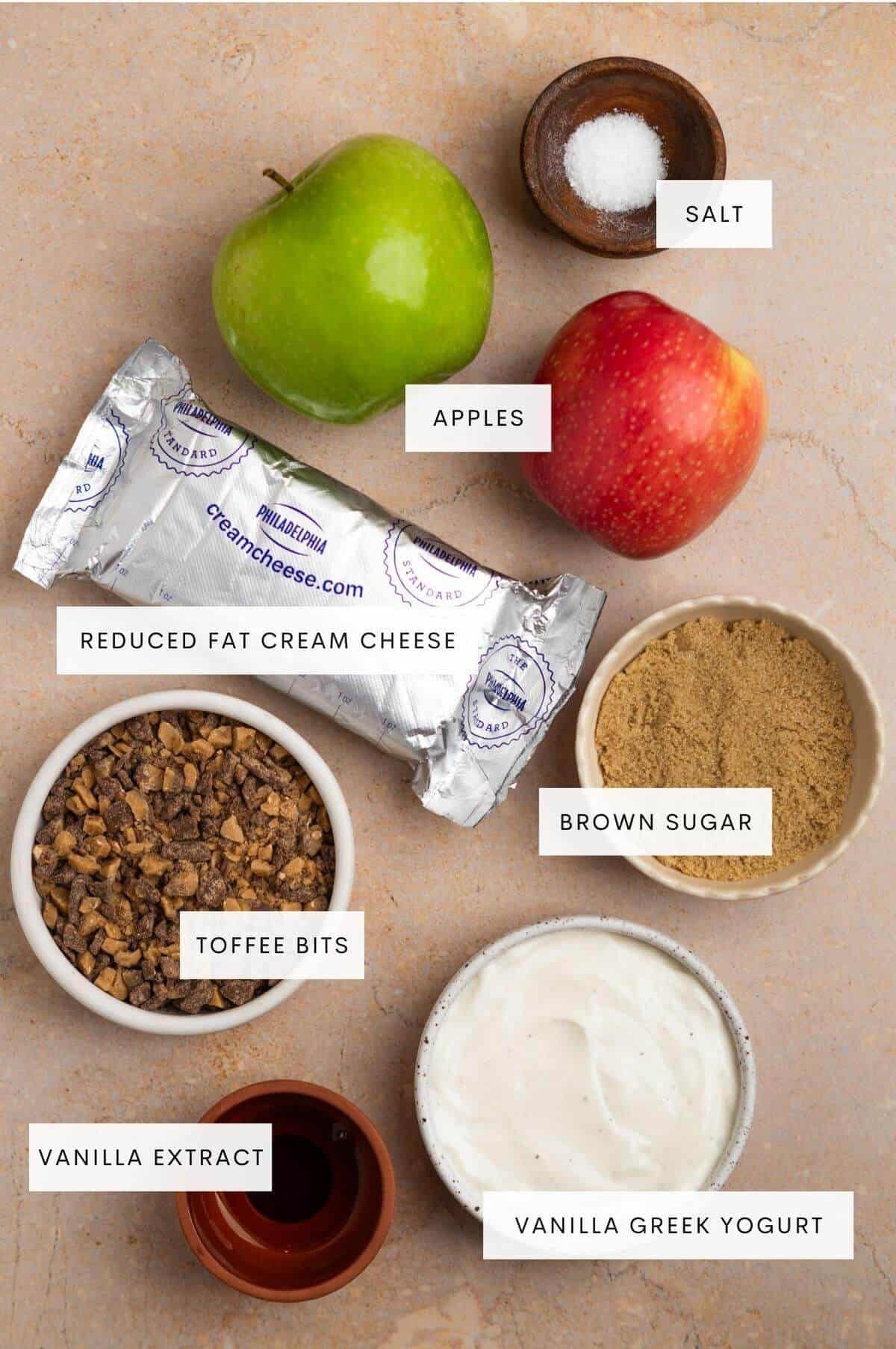 Ingredients needed for toffee apple dip: Apples, cream cheese, brown sugar, salt, vanilla Greek yogurt, vanilla extract, and salt.