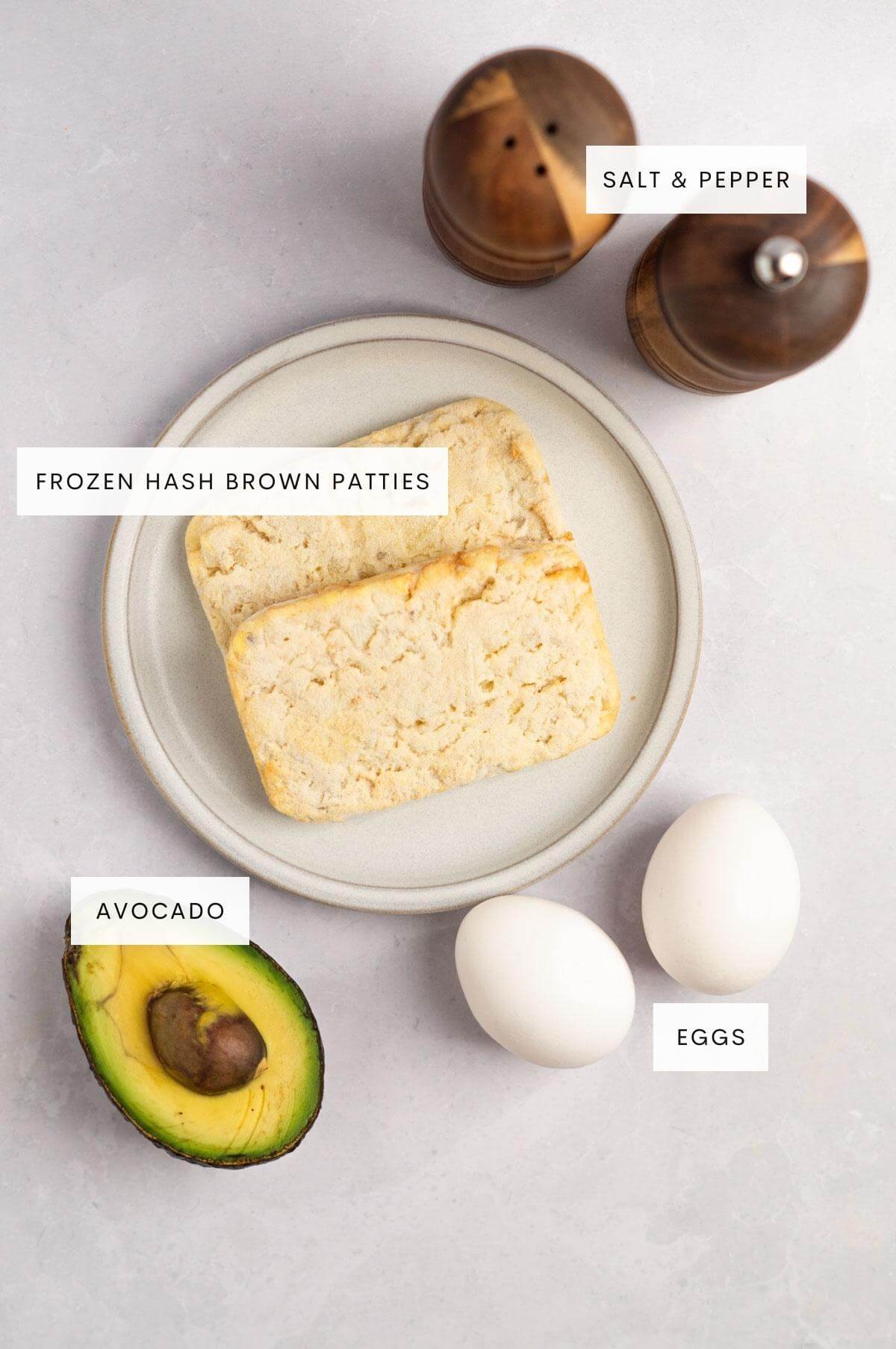 Ingredients needed for hash brown avocado toast: salt and pepper, frozen hash brown patties, eggs, and avocado.