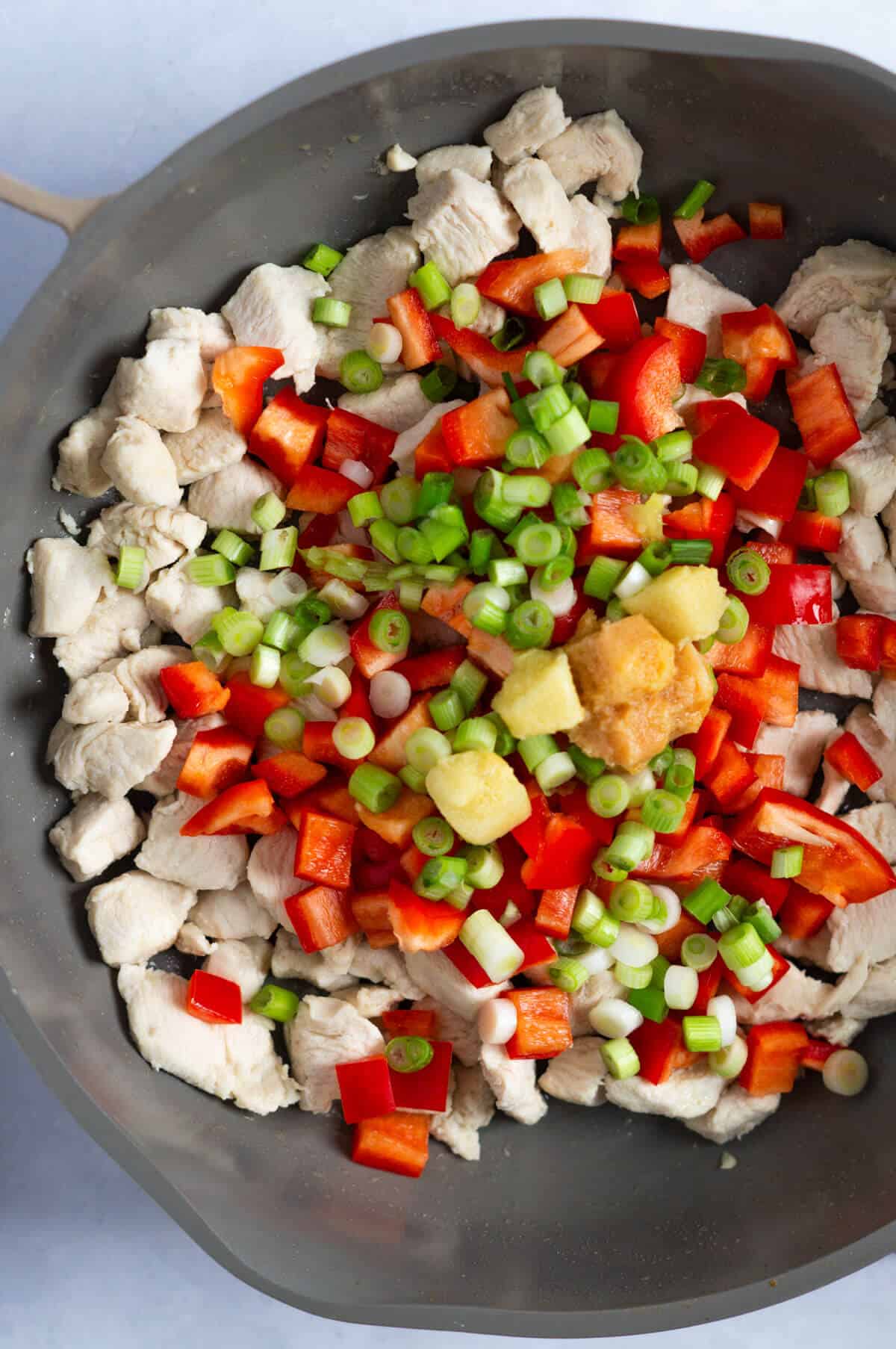 Pan of chicken, vegetables, and spices.