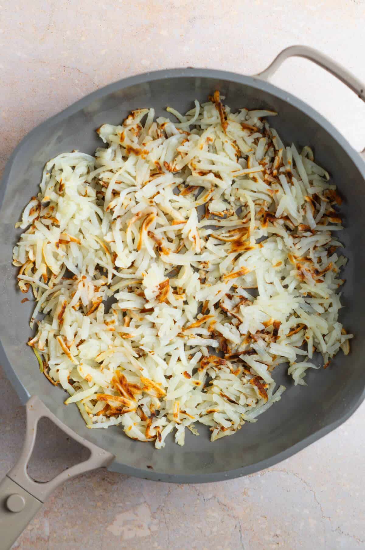A pan with crispy hashbrowns.