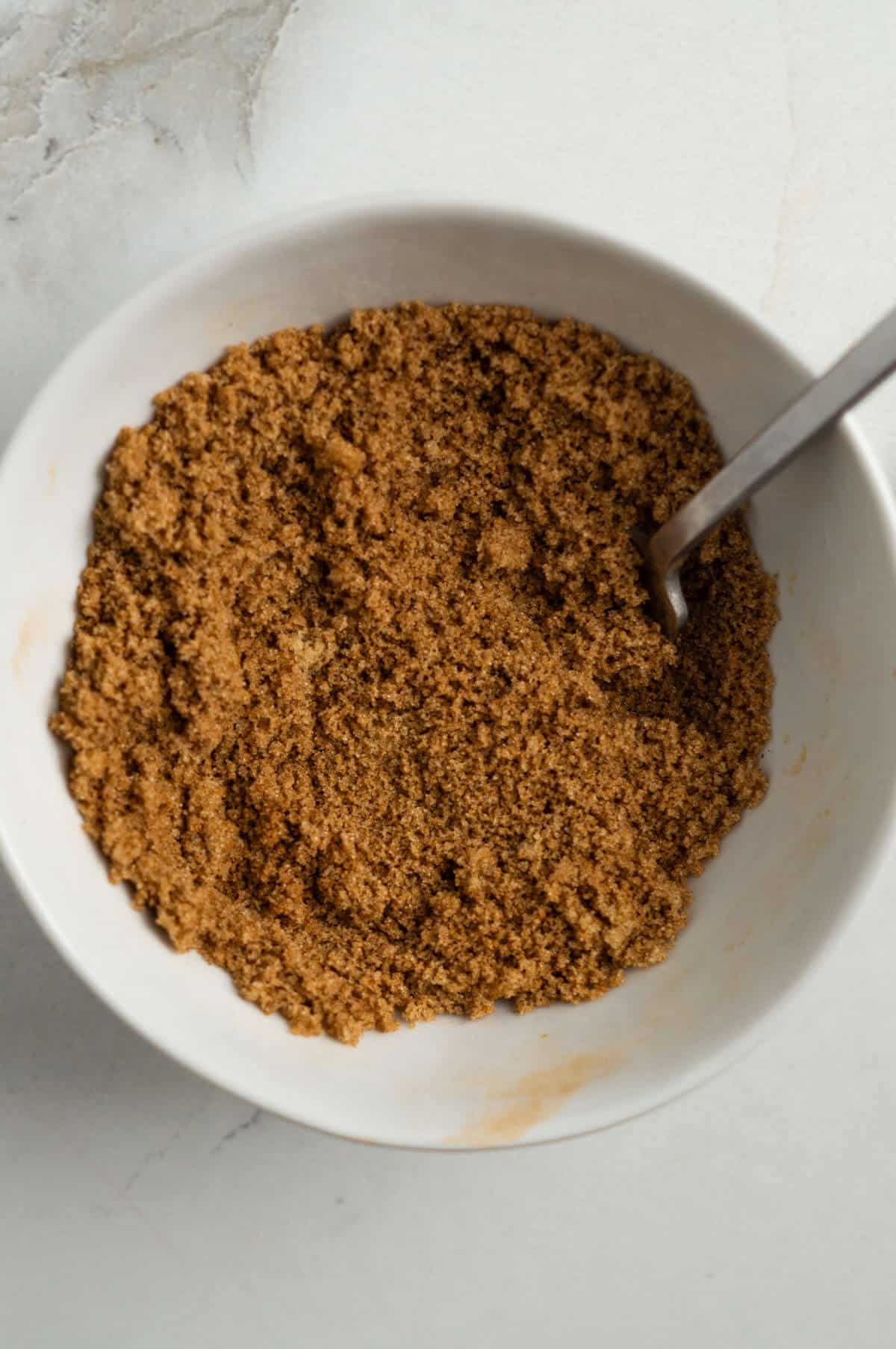 A small mixing bowl with the brown sugar and cinnamon mixture.