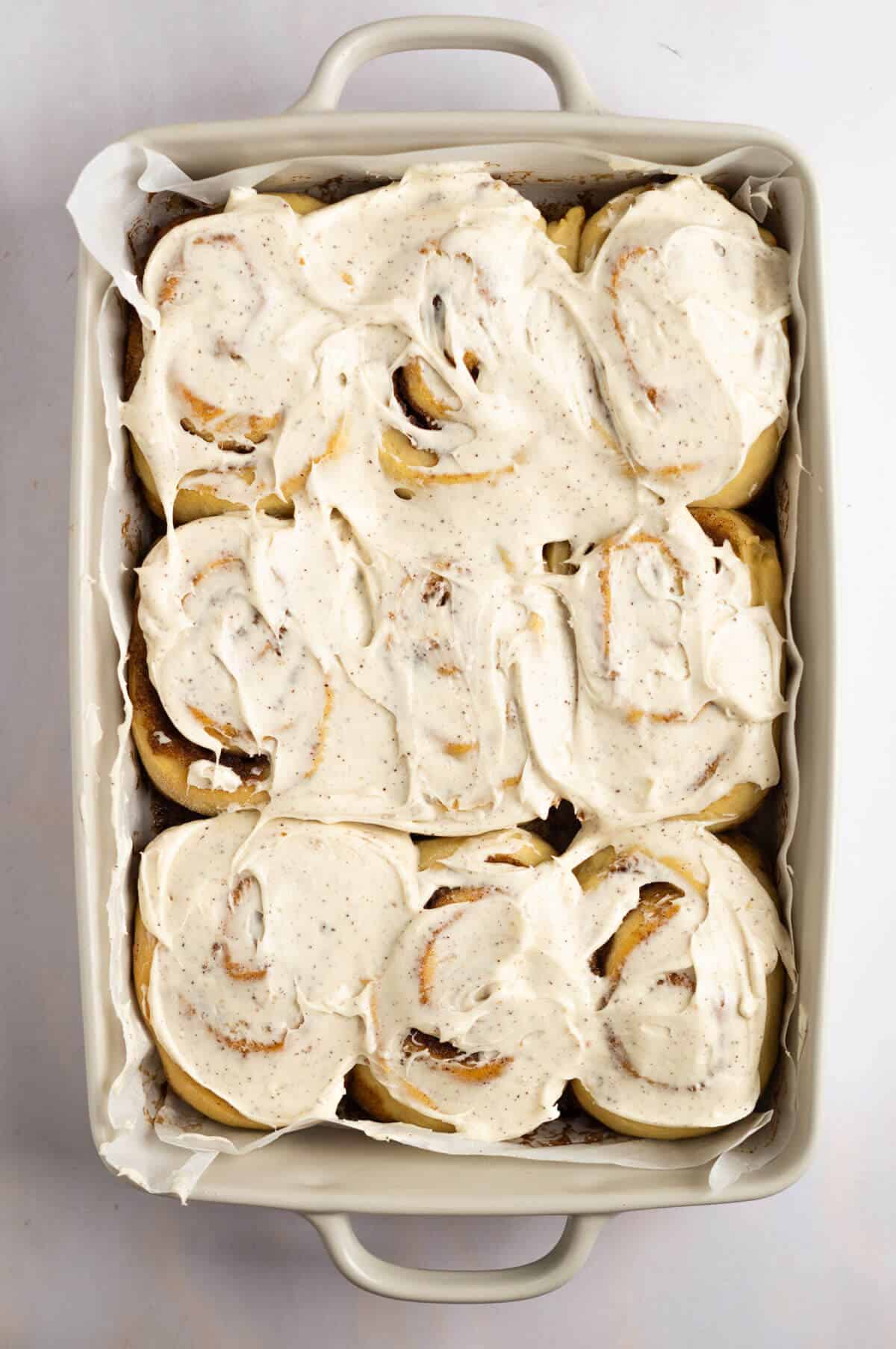 The cooked cinnamon rolls covered with the brown butter frosting.