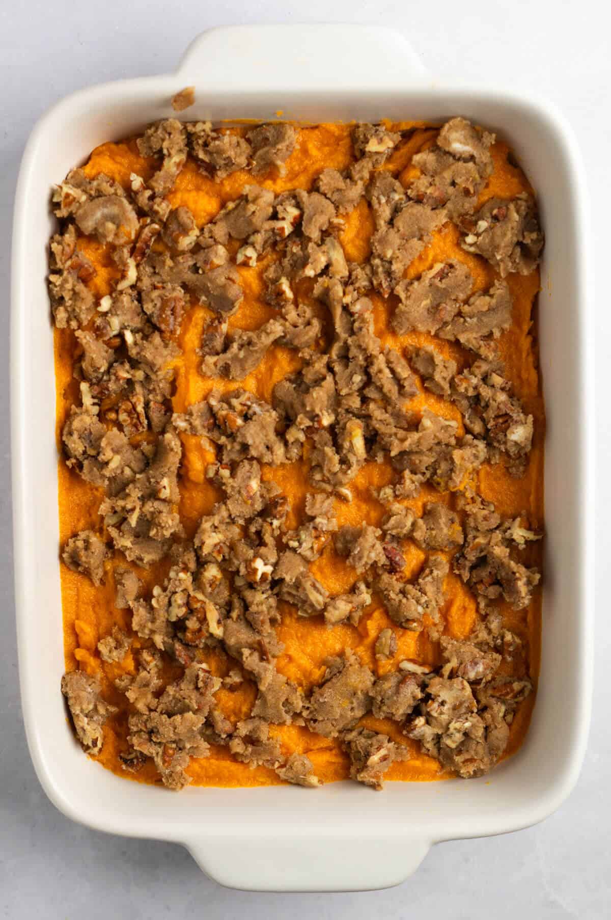 Unbaked sweet potato casserole topped with brown sugar pecan crumble.