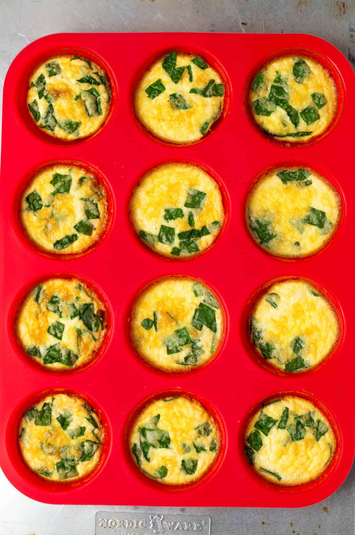 A silicone muffin tin with cooked egg bites.
