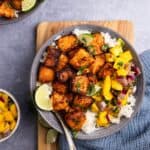 Hot honey salmon bites with mango salsa and jasmine rice and lime.