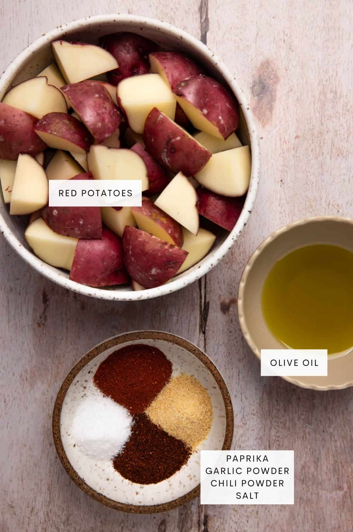 Bowl of red potatoes, olive oil, and spices.