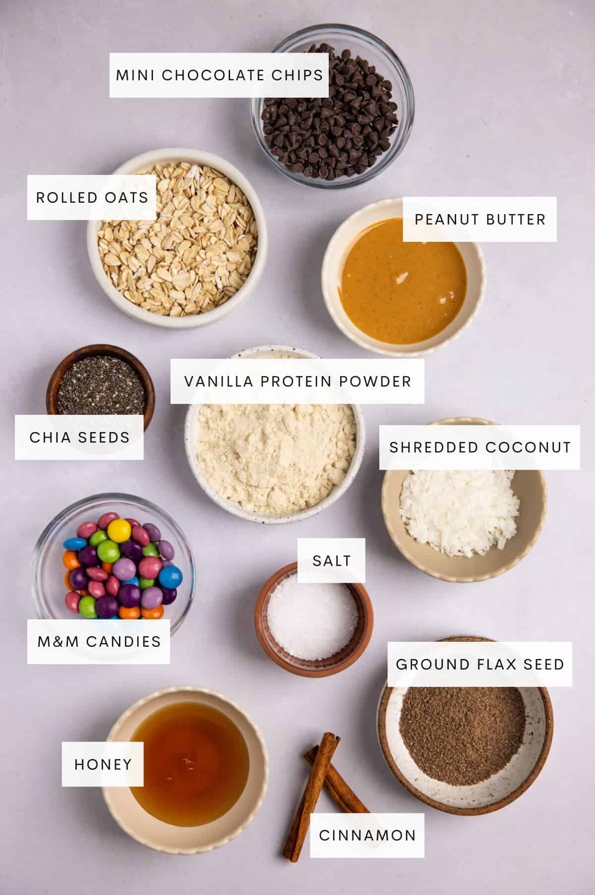 Picture of all of the ingredients in monster cookie protein balls in small bowls.