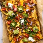 Overhead shot of a baking sheet filled with ground turkey nachos.