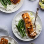 An overhead shot of a plate of miso butter salmon served with rice and snow peas.