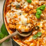 Close up of Skillet lasagna with basil on top.