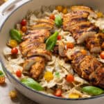A side view of a large pot of parmesan chicken pasta.