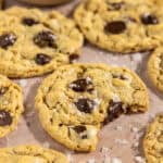 Up close shot of a brown butter oatmeal chocolate chip cookie with a bite taken out of it.