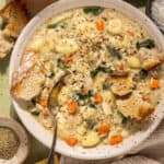 Overhead shot of a bowl of creamy chicken and gnocchi soup.