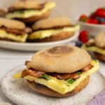 A plate with a prepared breakfast sandwich.