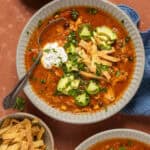Overhead shot of a bowl of chicken tortilla soup.