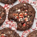 An up close shot of peppermint chocolate cookies with a bite taken out of it.