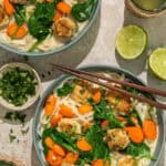Two large bowls of Thai inspired meatball soup with veggies.