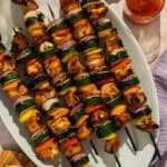 A platter with chicken and veggie skewers.