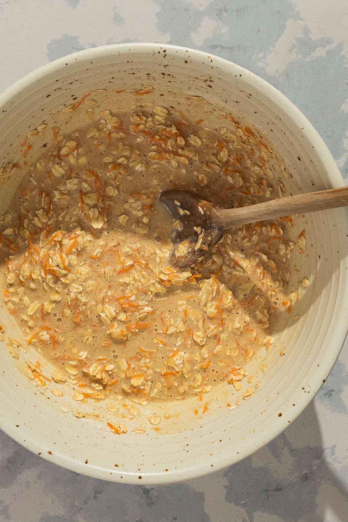 A large mixing bowl of the carrot cake baked oats batter.