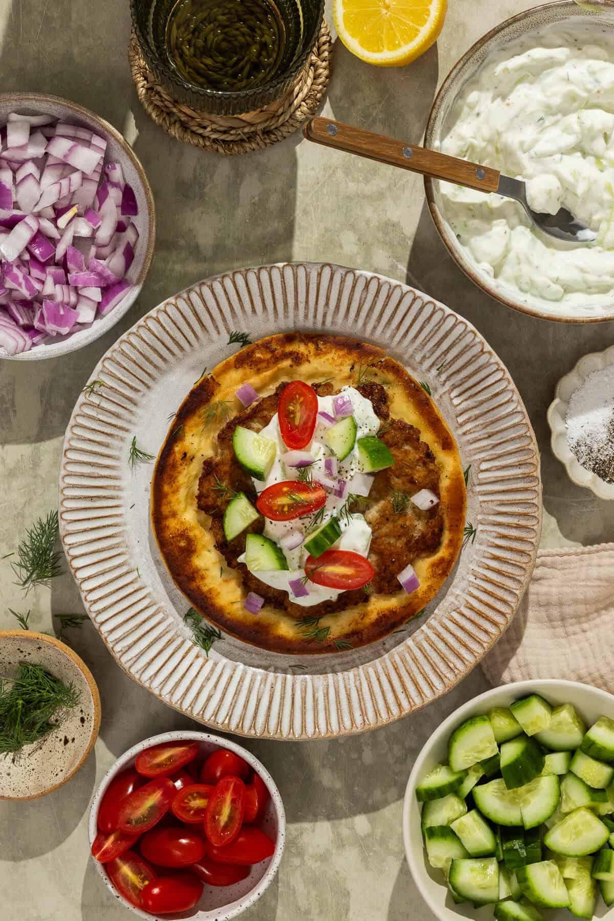 A plate with a prepared Greek smash pita.