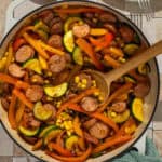 A large skillet with the completed sausage and veggie skillet.