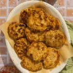 A parchment-lined platter with maple chicken sausage patties.