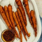 Apricot chili roasted carrots on a platter.