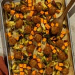 A parchment lined sheet pan of the fall meatball sheet pan recipe.