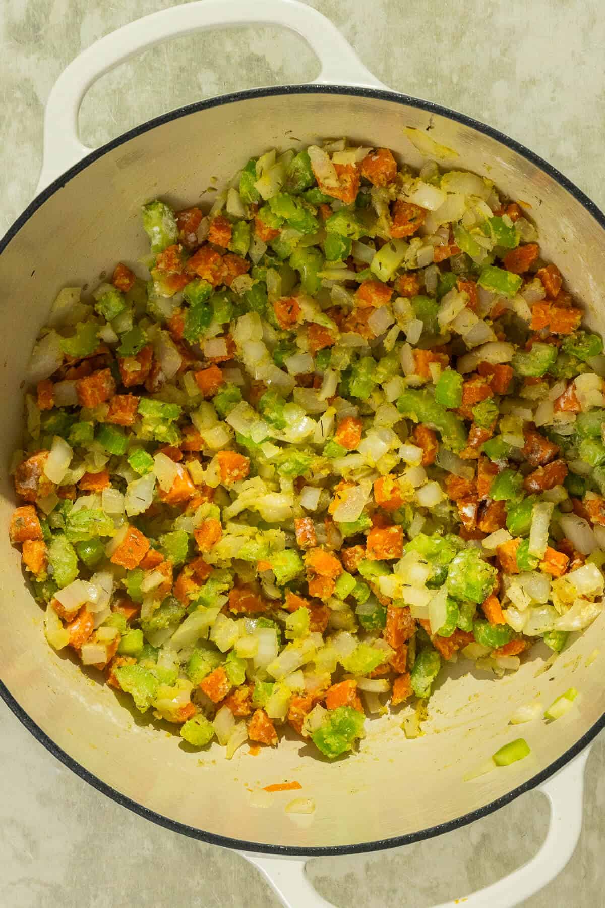 The pot of onion, carrots, and celery combined with the spices and flour.