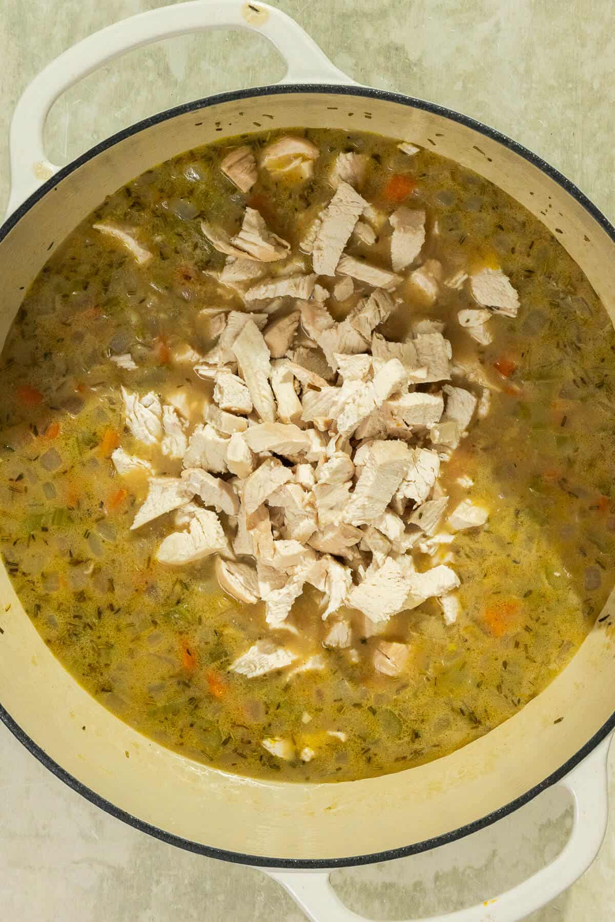 Diced chicken added back into the soup pot.
