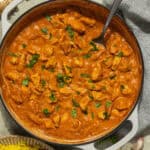 A large skillet with butter chicken.