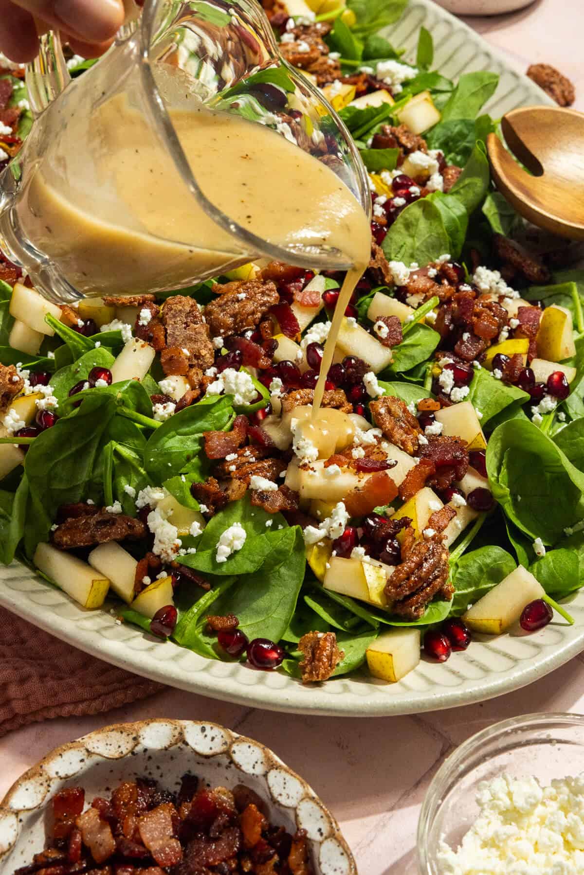 Salad dressing poured onto the spinach salad.