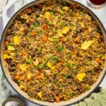 A large skillet with completed beef fried rice.