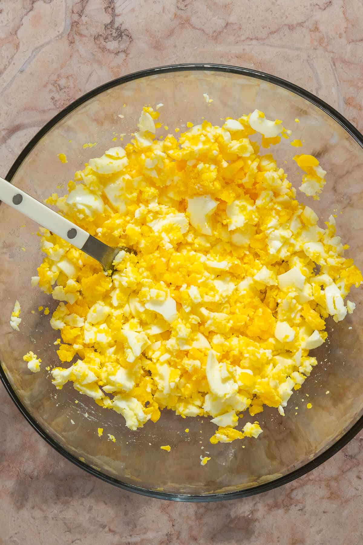 A bowl with mashed hard boiled eggs.