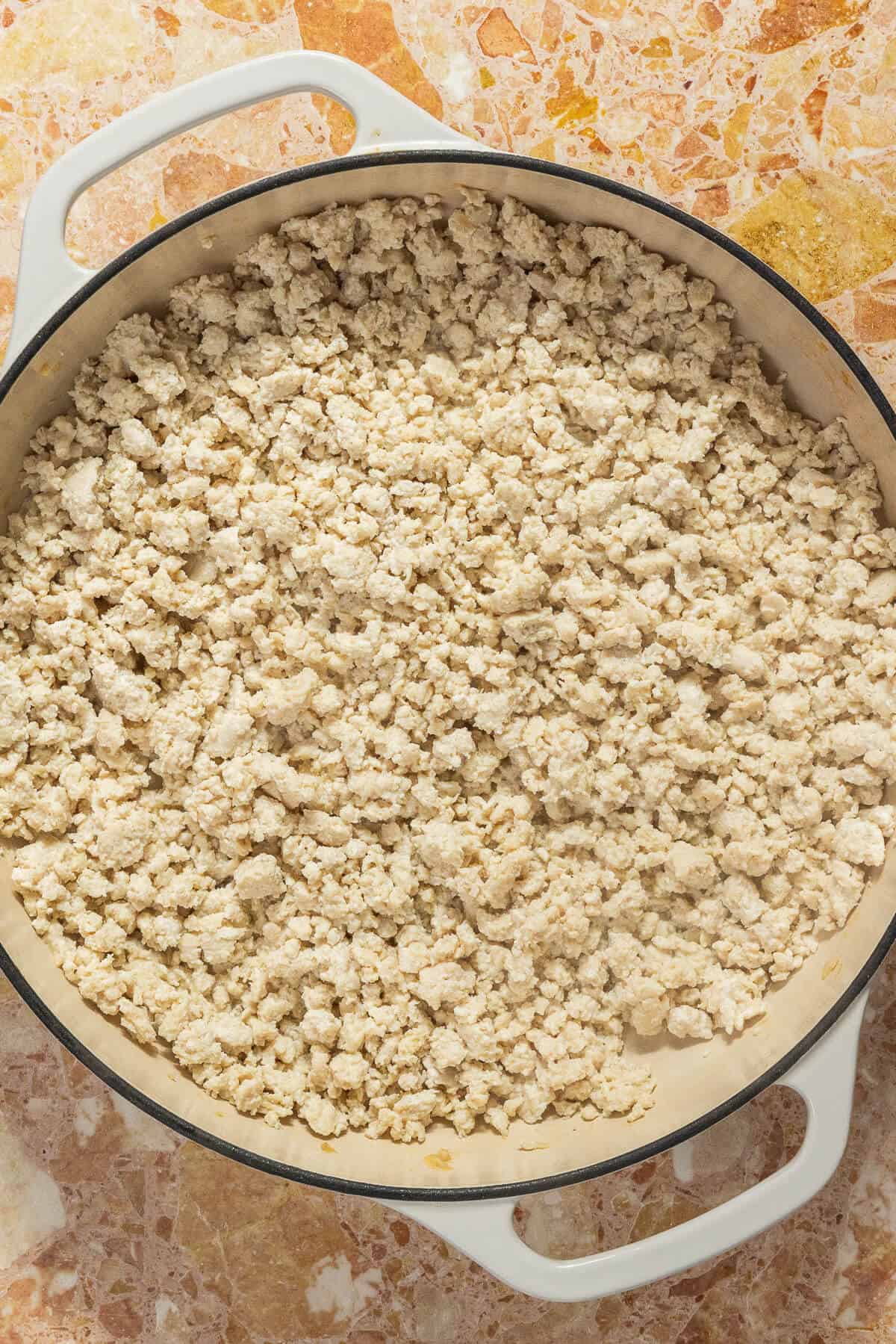 A large pan of ground chicken.