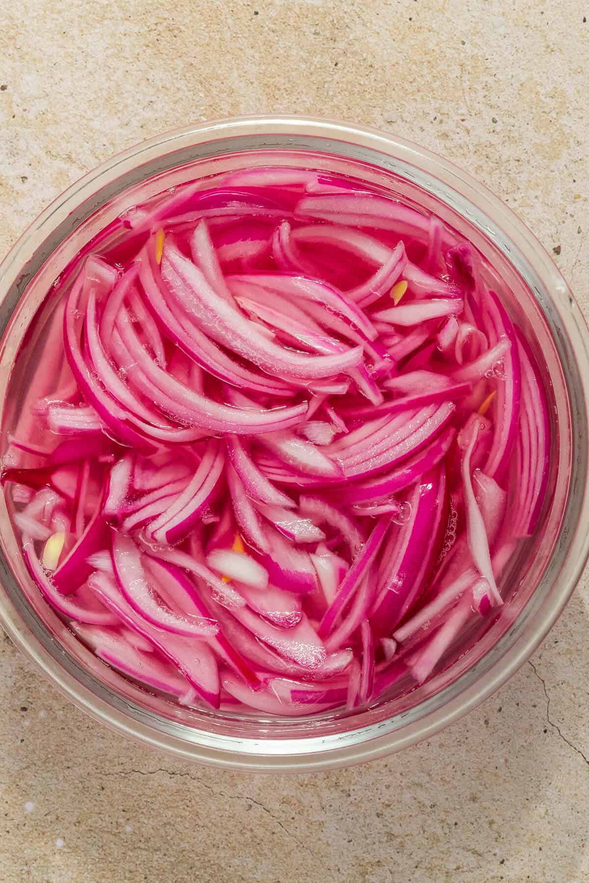 An overhead shot of a jar of pickled red onions.