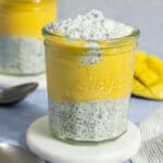 A glass jar with layered mango chia pudding.