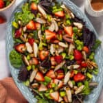 A large blue platter with strawberry pistachio salad.