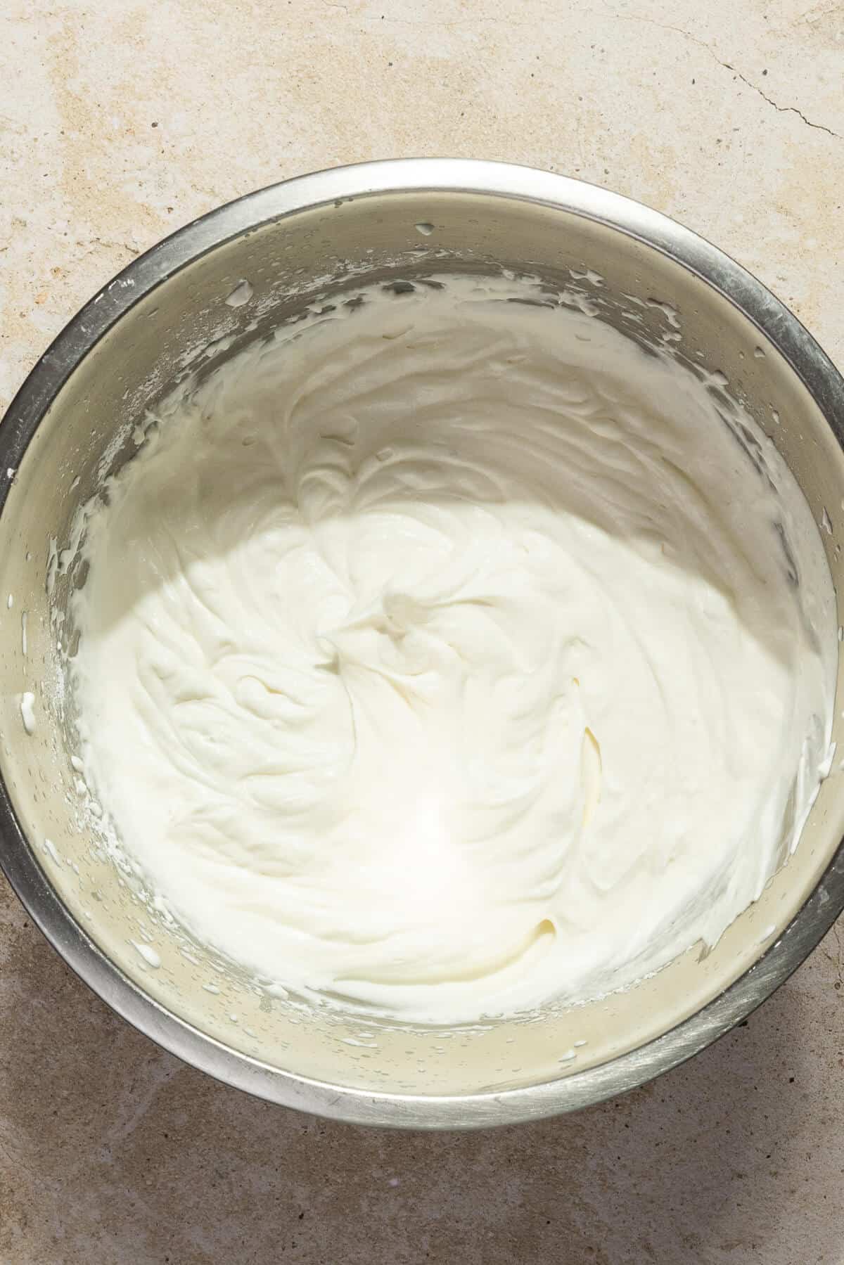 A large mixing bowl with home made whipped cream.