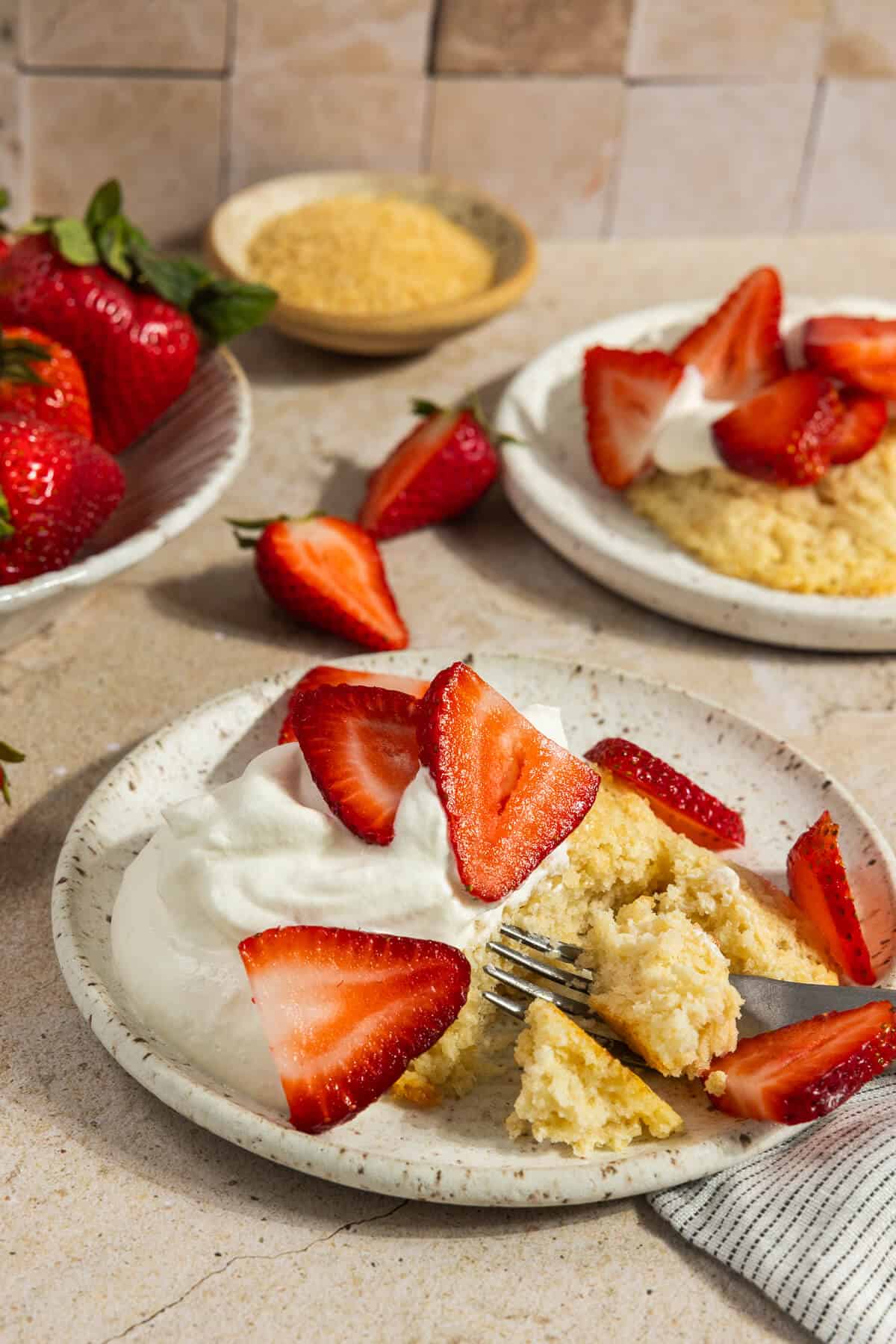 A plated strawberry shortcake with whipped cream.